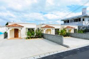 a large white house with a large driveway at Bears Stay Kumejima Villa - Vacation STAY 00998v in Kumejima