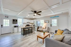 a living room with a couch and a ceiling fan at Rice Creek Hideaway with Private Dock and Boardwalk 