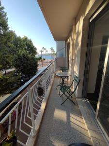 a balcony with a table and chairs and a view of the beach at Brand new 2 bdr apartment in Antibes with AC and sea view in Antibes