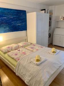 a bedroom with a bed with two hats on it at Apartment St. Marko in Zagreb