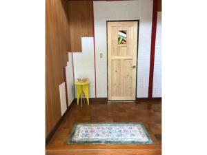 a hallway with a door and a rug on the floor at Hinata Sanso - Vacation STAY 02668v in Azumino