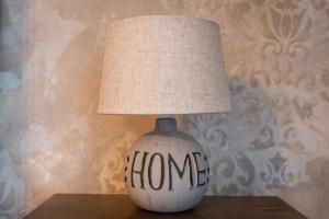 a lamp with the word home written on it at Dervent Apartment in Veliko Tŭrnovo