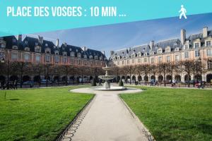 a park with a fountain in front of a large building at 3 Suites appartement in Paris