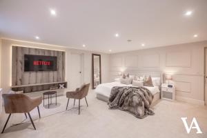 a bedroom with a bed and a tv on the wall at Velvet Apartments - 10 Park Square East in Leeds