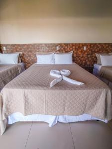 Cama ou camas em um quarto em POUSADA CAJUEIRO