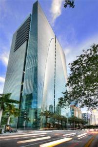 a tall glass building on the side of a street at Brickell Apt Free Parking 4 People Pool Ocean View in Miami