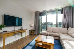 a living room with a couch and a flat screen tv at Two bed apartment in Sandyford in Sandyford