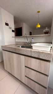 a kitchen with a sink and a counter top at Ap Confort Premium in Campinas