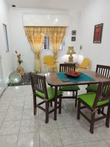 a dining room with a wooden table and chairs at LA FATIMA in Gualeguaychú