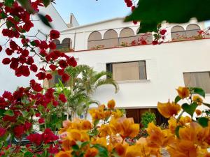 a white building with flowers in front of it at Casa Bella Boutique Hotel San Isidro in Lima
