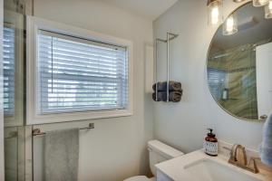 a bathroom with a window and a sink and a mirror at Waterfront Gloucester Cottage with Private Boat Dock in Gloucester +31 photos