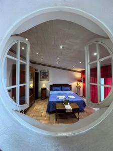 a bedroom with a blue bed and a round window at villa Angelina house in Ripa Teatina