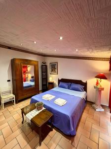 a bedroom with a large bed and a table at villa Angelina house in Ripa Teatina