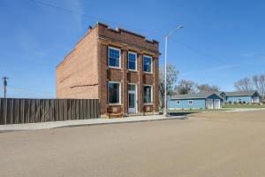 an old brick building on the side of a street at Spacious South Dakota Retreat Near Golfing! in Dante