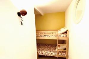 a small room with a bunk bed in a room at Appart neuf 50m² Porquerolles centre du village in Porquerolles