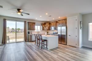 a kitchen with wooden floors and a ceiling fan at Modern Fort Mohave Home with Patio and Grill! in Fort Mohave