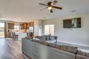 a living room with a couch and a ceiling fan at Modern Fort Mohave Home with Patio and Grill! in Fort Mohave