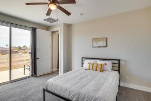 a bedroom with a bed and a ceiling fan at Modern Fort Mohave Home with Patio and Grill! in Fort Mohave