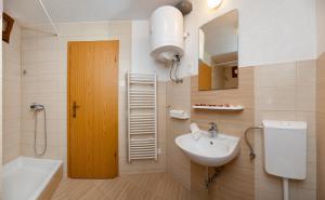 a bathroom with a sink and a toilet and a shower at Apartments Mande and Kate in Baška Voda +19 photos