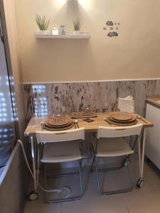 a kitchen with a table with plates on it at La Baraka de Guadalmar B&B Aeropuerto , Free breakfast in Málaga