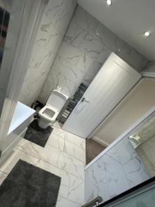 a bathroom with a toilet and a sink at 5 bedroom house in Orpington in Orpington