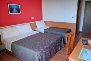 Postel nebo postele na pokoji v ubytování Hotel Fenix