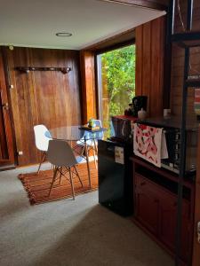 a kitchen with a table and a table and a chair at Valdivia Base Camp-Estudio Privado in Valdivia