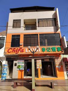 a building with a sign that reads chinese liquor at Hostal Boulevard in Nazca