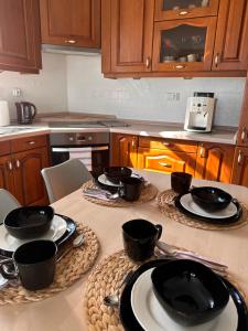 a kitchen with a table with plates and utensils on it at Dom nad jeziorem in Jeziorany