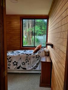 a bedroom with a bed and a window at Valdivia Base Camp-Estudio Privado in Valdivia