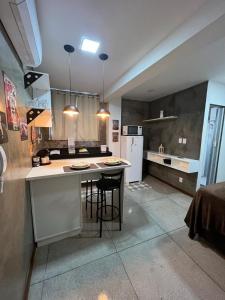 a kitchen with a island in the middle of a room at STUDIO 304 | WIFI 600MB | RESIDENCIAL JC, um lugar para ficar. in Belém