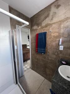 a bathroom with a sink and a towel on the wall at STUDIO 304 | WIFI 600MB | RESIDENCIAL JC, um lugar para ficar. in Belém