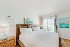 a bedroom with a white bed and a window at Aloha, Sunset on the Bay in Padre Island +45 photos