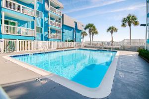 a swimming pool in front of a apartment building at Sight of the Sea in Myrtle Beach