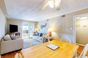 a living room with a table and a couch at Sight of the Sea in Myrtle Beach