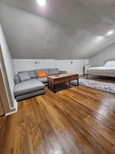 a living room with a couch and a bed at Clinton Studio in Lafayette