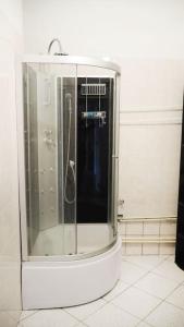 a shower with a glass door in a bathroom at Central Apartament Dworskiego in Przemyśl