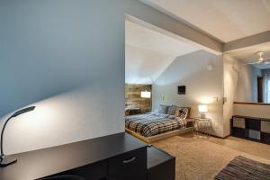 a bedroom with a bed and a desk with a lamp at Large Home with Game Room, 4 Mi to Mississippi River in Bettendorf +26 photos