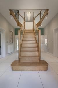 a staircase in a home with a wooden stair case at The Heyford Hotel in Upper Heyford