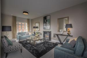 a living room with two blue couches and a fireplace at The Heyford Hotel in Upper Heyford
