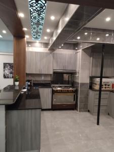 a large kitchen with stainless steel appliances in a room at Best view , New furniture Gameat Al Dewal Al Arbeya in Cairo