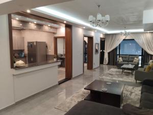 a large living room with a couch and a kitchen at Best view , New furniture Gameat Al Dewal Al Arbeya in Cairo