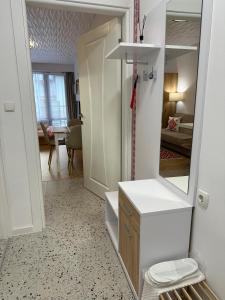 a bathroom with a vanity and a mirror and a room at Studio Shevitsa & free Garage in Veliko Tŭrnovo