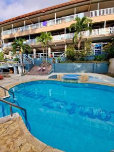 a large swimming pool in front of a building at Hotel Ticozuma in Montezuma