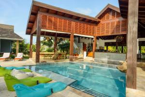 a villa with a swimming pool and a house at The Enclave - Your Own Private Island Retreat in Placencia Village