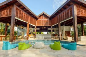 a villa with a swimming pool and a house at The Enclave - Your Own Private Island Retreat in Placencia Village