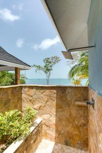 an outdoor shower with a view of the ocean at The Enclave - Your Own Private Island Retreat in Placencia Village