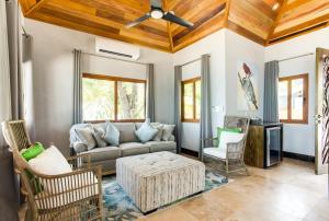 a living room with a couch and chairs at The Enclave - Your Own Private Island Retreat in Placencia Village