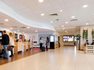 a group of people standing in a lobby at ibis Paris 17 Clichy-Batignolles in Paris