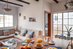 a living room with a table with food on it at Delmar La Graciosa in Caleta de Sebo